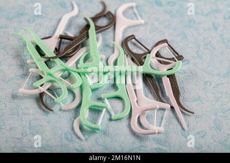 Colorful toothpick. Assorted colors dental floss pick on the color background. Stock Photo