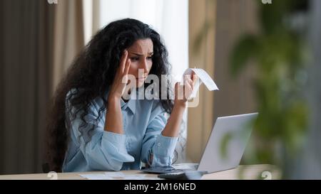 Worried upset young businesswoman accountant bookkeeper bank worker feel stressed about high tax check costs outcomes utility bills unpaid bank debt s Stock Photo