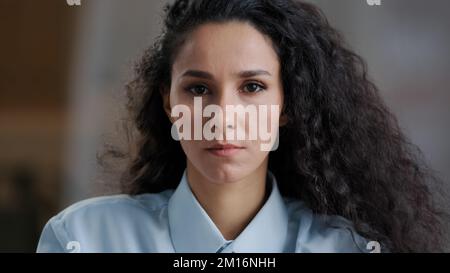 Portrait female upset face arab girl attractive hispanic woman with curly hair natural makeup sad model student serious offended frustrated facial exp Stock Photo