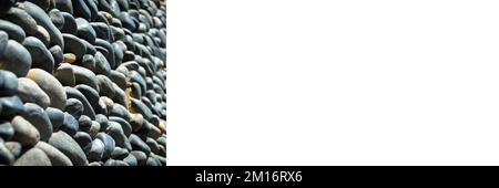 Wall texture decorated with blue pebbles, pebbles glued to the wall, background pebble wall texture, banner mock up poster desing Stock Photo