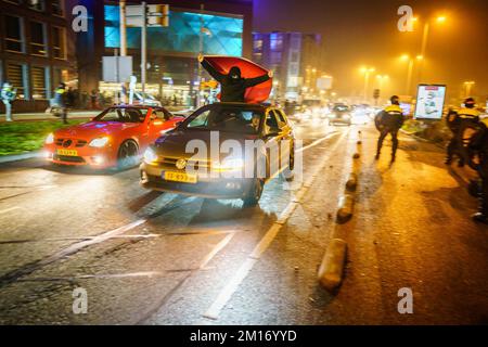 Dutch police watch fans of Morocco celebrating their team's victory in the FIFA World Cup quarter final between Morocco and Portugal in Lombok, Utrecht, The Netherlands, 10 December 2022. ANP KOEN LAUREIJ netherlands out - belgium out Credit: ANP/Alamy Live News Stock Photo