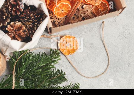 Zero waste and eco friendly christmas concept. Natural decorations and branches of a Christmas tree on the table, top view. Stock Photo