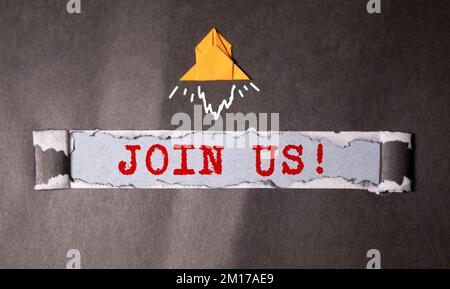 Join us - message appearing behind torn blue paper. Hiring and new job concept. Stock Photo