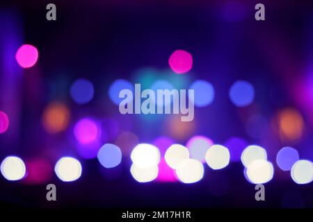 Defocus blurred abstract blue bokeh background. Festive spotted glitter background. Blurry music performance in rock band concert. Out of focus Stock Photo