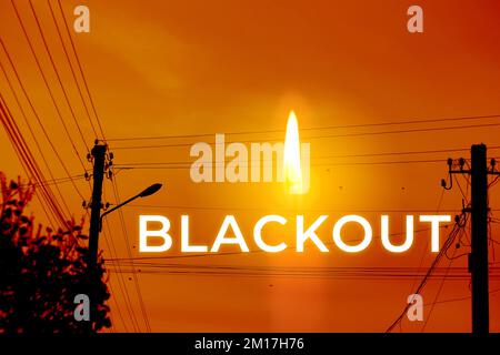 Blackout, power grid overloaded. Blackout concept. Earth hour. Burning flame candle and power lines on background. Energy crisis. Orange sky. Candle Stock Photo