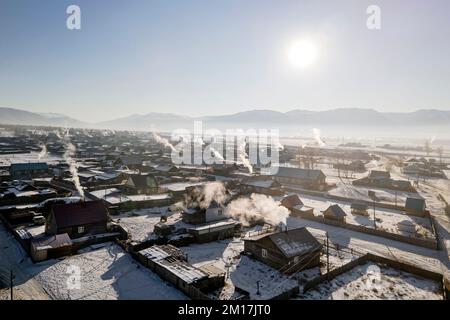 view of the russian village on a sunny winter day. View of the traditional country houses. Stock Photo