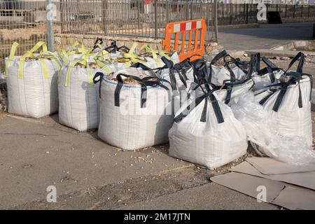 Large construction bags filled with construction debris on the construction site. cubic meter bags. Israel Stock Photo