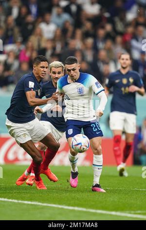 Al Khor, Qatar. 10th Dec, 2022. AL KHOR, QATAR - DECEMBER 10: Phil Foden of England battles for the ball with Raphael Varane  of France and Antoine Griezmann of France during the FIFA World Cup Qatar 2022 quarter final match between England and France at Al Bayt Stadium, on December 10, 2022 in Al Khor, Qatar.(Photo by Florencia Tan Jun/Pximages) Credit: Px Images/Alamy Live News Stock Photo