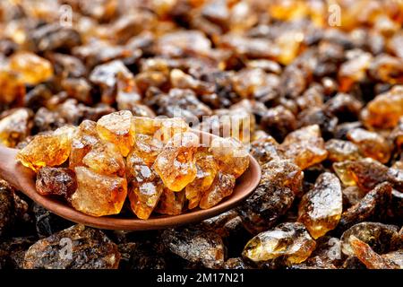 caramelized sugar in wooden spoon and on background Stock Photo