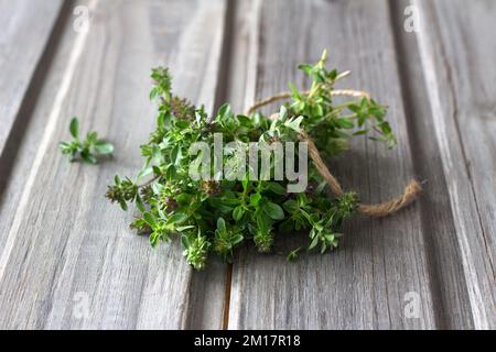 Bunch of thyme on wooden background, rustic style, selective focus Stock Photo