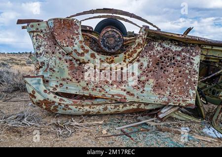 Rear passenger side quarter panel of an overturned truck in the Nevada desert Stock Photo