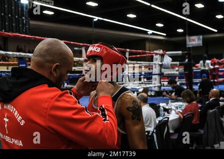 Lubbock, TX, USA. 10th Dec, 2022. Jason Moreno of Philadelphia has his headgear put on by his coach prior to his Elite Male 156lb championship bout with Amir Anderson of Syracuse, NY. (Credit Image: © Adam DelGiudice/ZUMA Press Wire) Credit: ZUMA Press, Inc./Alamy Live News Stock Photo