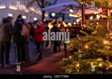 Meran, South Tyrol, Italy 02 December 2022 people eating and drinking at gastronomic stand at traditional famous christmas market Stock Photo