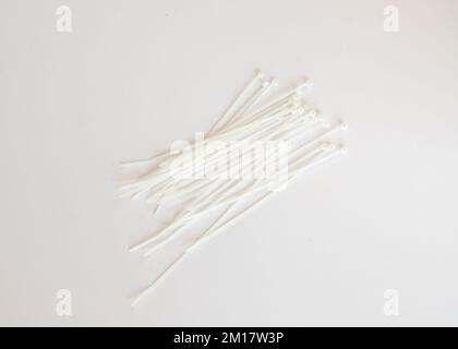 White plastic ties on white isolated background Stock Photo