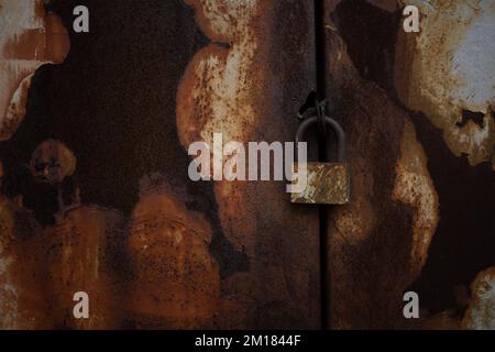 Detailed close up of industrial metal pipes network with rust and corrosion on dark corrugated wall background Stock Photo