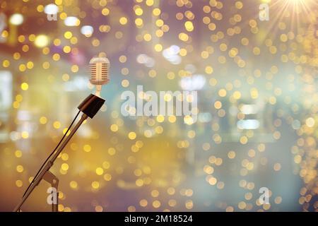 Retro Microphone On Stage With Bokeh Light. singing microphone with stage lighting background. Retro Microphone On Stage With Bokeh Light. colorful bo Stock Photo