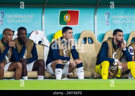 Doha, Qatar. 10th Dec, 2022. Soccer: World Cup, Morocco - Portugal, final round, quarterfinal, Al-Thumama Stadium, Portugal's Cristiano Ronaldo (M) sits on the bench during the match. Credit: Tom Weller/dpa/Alamy Live News Stock Photo