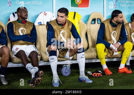 Doha, Qatar. 10th Dec, 2022. Soccer: World Cup, Morocco - Portugal, final round, quarterfinal, Al-Thumama Stadium, Portugal's Cristiano Ronaldo (M) sits on the bench before the match. Credit: Tom Weller/dpa/Alamy Live News Stock Photo