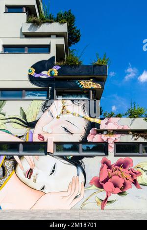 A colorful graffity with japanese motive is painted at a house wall Stock Photo