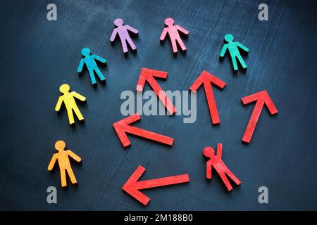 Colorful figures and red one with arrows. Inclusive communication and leadership concept. Stock Photo