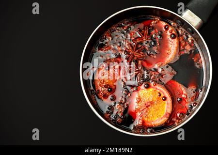 Hot mulled wine boiled in a pot, top view Stock Photo