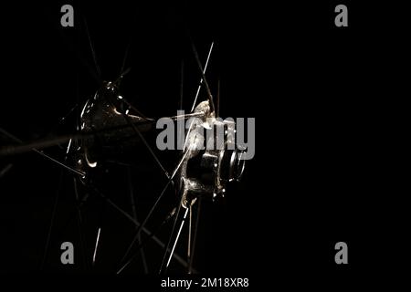 Low light photo of mountain bike front hub and wheel on black background with copy space Stock Photo
