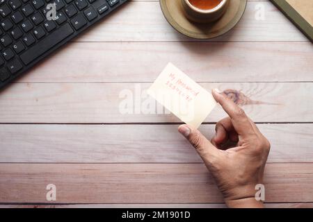 holding a card hand writing password text  Stock Photo