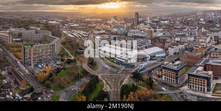 SHEFFIELD, UK - DECEMBER 6, 2022.  An aerial panorama of Sheffield city centre cityscape skyline at sunset with Ponds Forge swimming pool and Park Hil Stock Photo
