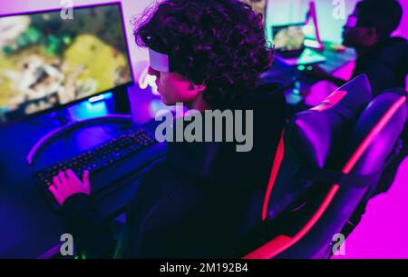 Pro woman egame cyber playing online with virtual reality headset and  wireless controller. Virtual space shooter championship in cyberspace,  esports player performing on pc during gaming tournament Stock Photo - Alamy