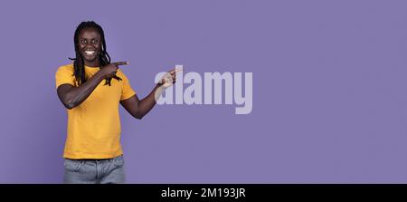 Cool african american young man pointing at copy space, panorama Stock Photo