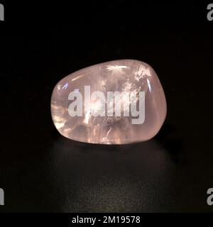 Macro close up colour photograph of 'Rose Quartz' a semi precious crystal gemstone used in crystal healing therapy Stock Photo
