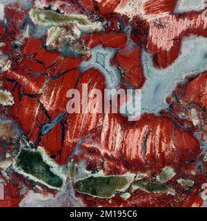 Macro close up colour photograph of Palmstone 'Poppy Jasper' a semi precious crystal gemstone used in crystal healing therapy Stock Photo