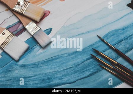 Artist props collection on table. composition of messy stationery tools for drawing Stock Photo