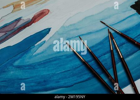 Artist props collection on table. composition of messy stationery tools for drawing Stock Photo