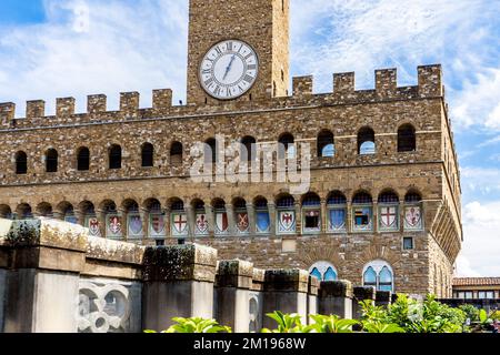 Coats of arms in the façade of Palazzo Vecchio with Florentine red lily, seen from the terrace of Uffizi gallery, Florence city center, Tuscany, Italy Stock Photo