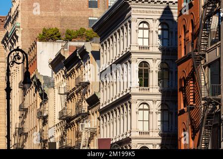 Cast iron facades of Soho loft buildings with fire escapes. Soho Cast Iron Building Historic District along Broadway, Lower Manhattan, New York City Stock Photo