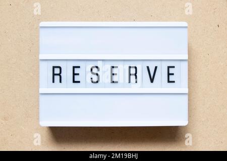 Lightbox with word reserve on wood background Stock Photo