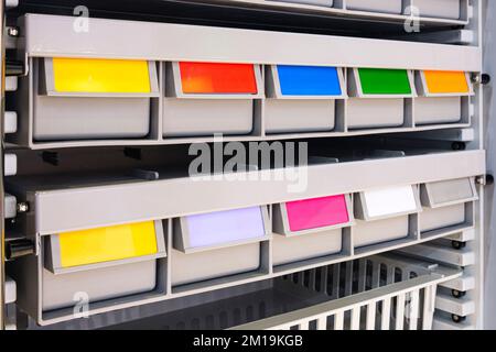 rows of multicolored plastic boxes for components Stock Photo