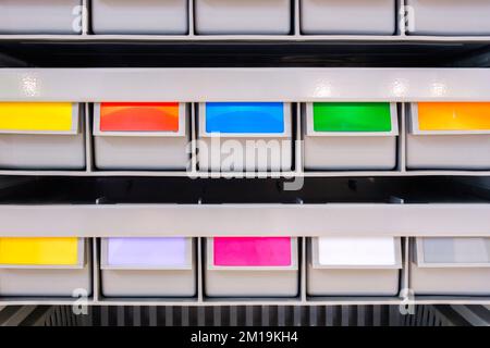 rows of multicolored plastic boxes for components Stock Photo