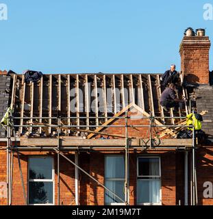 Builders in work clothes install new roofing tools, roofing tools, electric drill and use them on new wooden roofs with metal sheets.Limerick,Ireland, Stock Photo