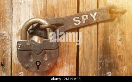 Security concept. There is a lock on the door on the metal part of which it is written - SPY Stock Photo