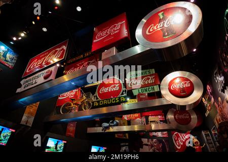 A display of Coke signs from around the world at the World of Coca Cola Stock Photo