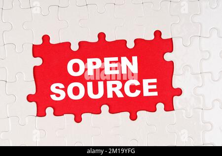 Business and finance concept. In the middle of the puzzles on a red background it is written - OPEN SOURCE Stock Photo