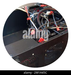 Desktop computer, black empty case and various cables, which are tried to be assembled in a home environment Stock Photo