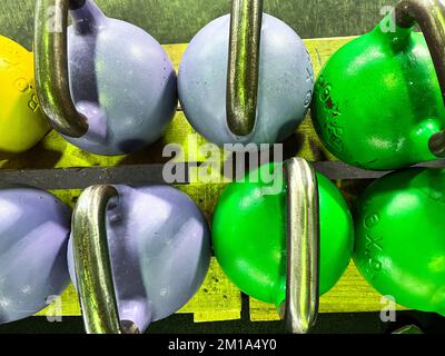 Colorful kettlebells in a gym row Stock Photo