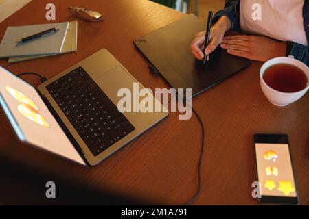 Cropped image of a graphic designer using digital tablet in his work at home office Stock Photo