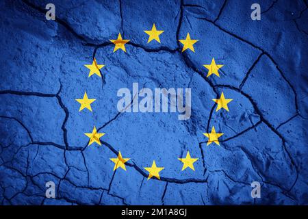 Flag of the European Union. European Union symbol. Flag on the background of dry cracked earth. Flag with drought concept Stock Photo