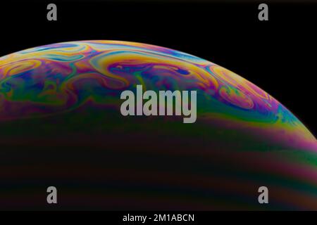 Soap bubble close up on black background. Stock Photo