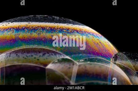 Soap bubble close up on black background. Stock Photo