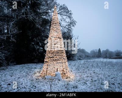 A Christmas tree shaped lighted decoration in a field. Wellesbourne, England UK. Stock Photo